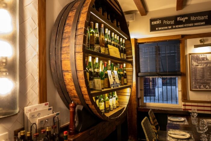 Small wall wine display inside a big barrel shelve