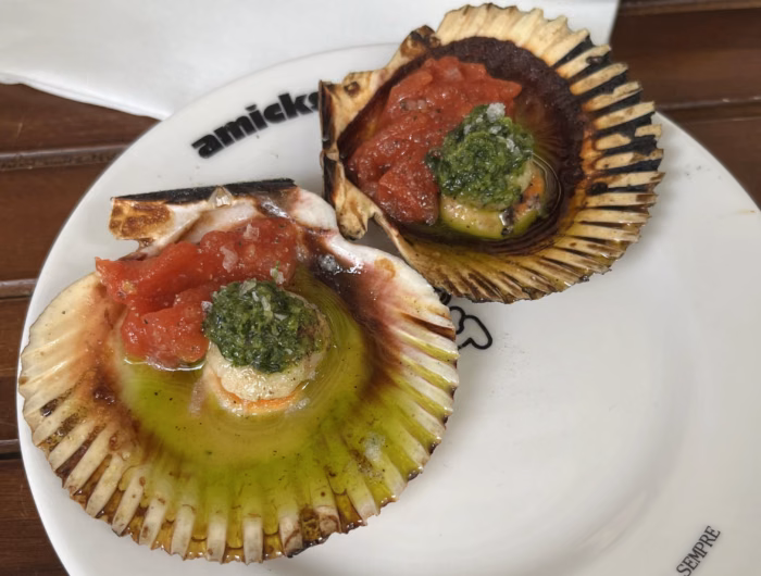 Fire grilled scallops with tomato confit and garlic and parsley oil