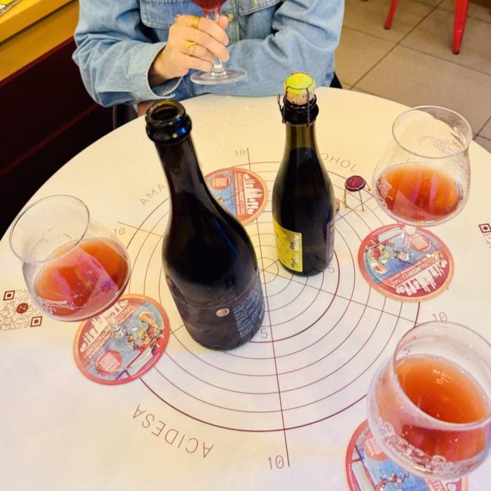 A bottle of craft beer is displayed on a table as part of a barcelona craft beer tour