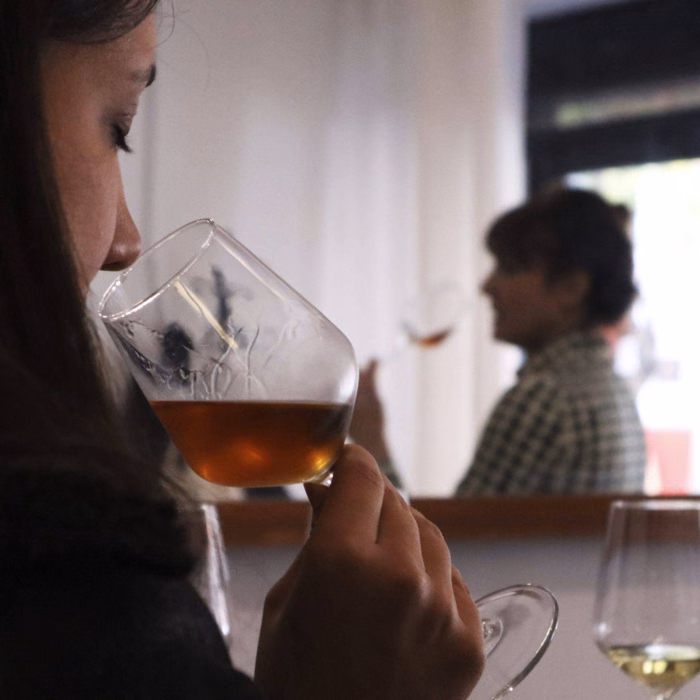 a woman sniffing a glass of sherry during a barcelona wine tasting